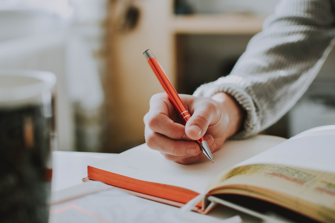 An editor reviewing a printed document with a red pen
